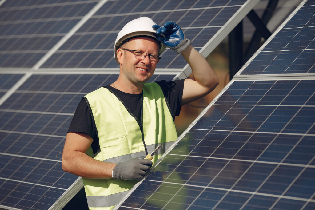 Technician performing maintenance on solar panel system
