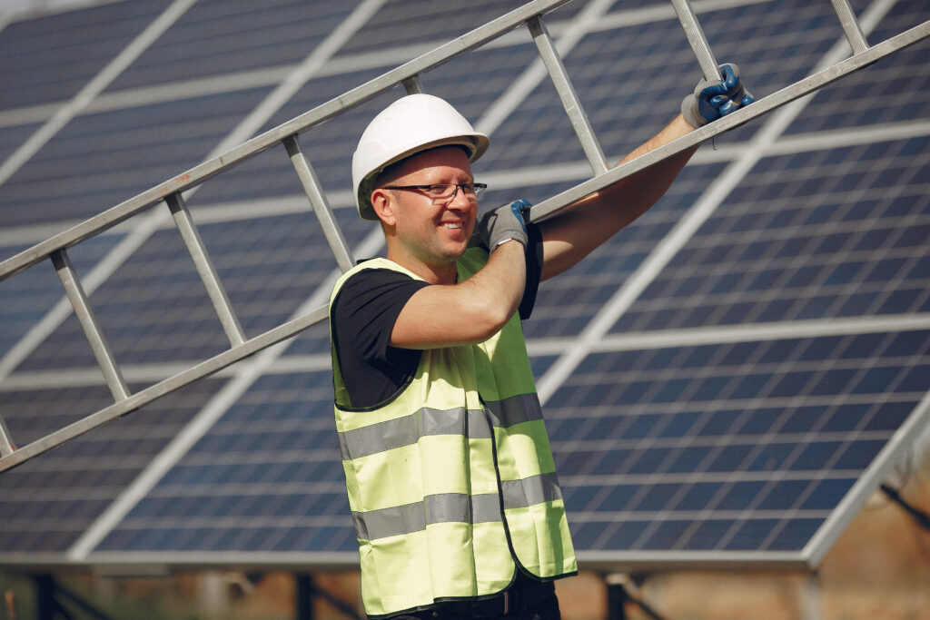 Technician performing maintenance on solar panel system