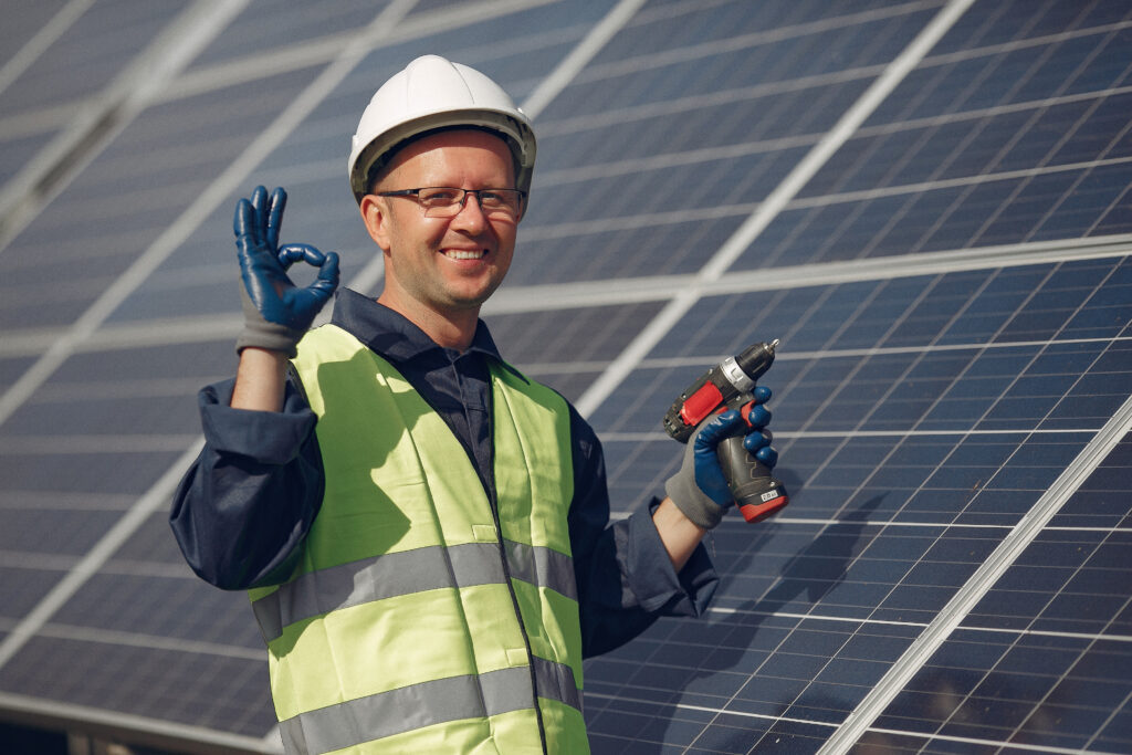 Technician performing maintenance on solar panel system